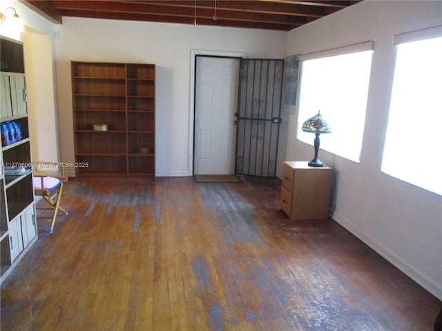 105 NW 32nd Pl, Miami, FL 33125 - unfurnished room with hardwood / wood-style floors, baseboards, and beamed ceiling