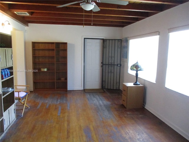 105 NW 32nd Pl, Miami, FL 33125 - empty room with ceiling fan, wood finished floors, beam ceiling, and baseboards