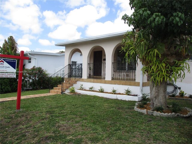 105 NW 32nd Pl, Miami, FL 33125 - office area featuring wood finished floors, wood walls, and ceiling fan