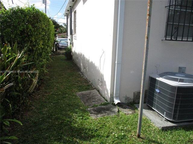 105 NW 32nd Pl, Miami, FL 33125 - view of side of home featuring central AC and stucco siding