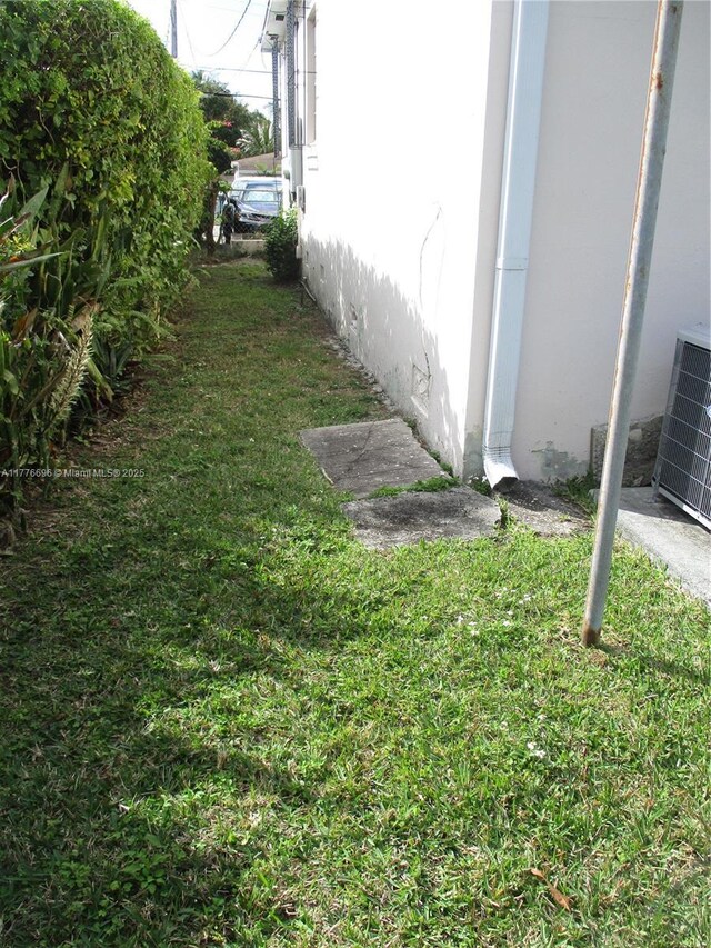 105 NW 32nd Pl, Miami, FL 33125 - view of home's exterior with cooling unit and stucco siding