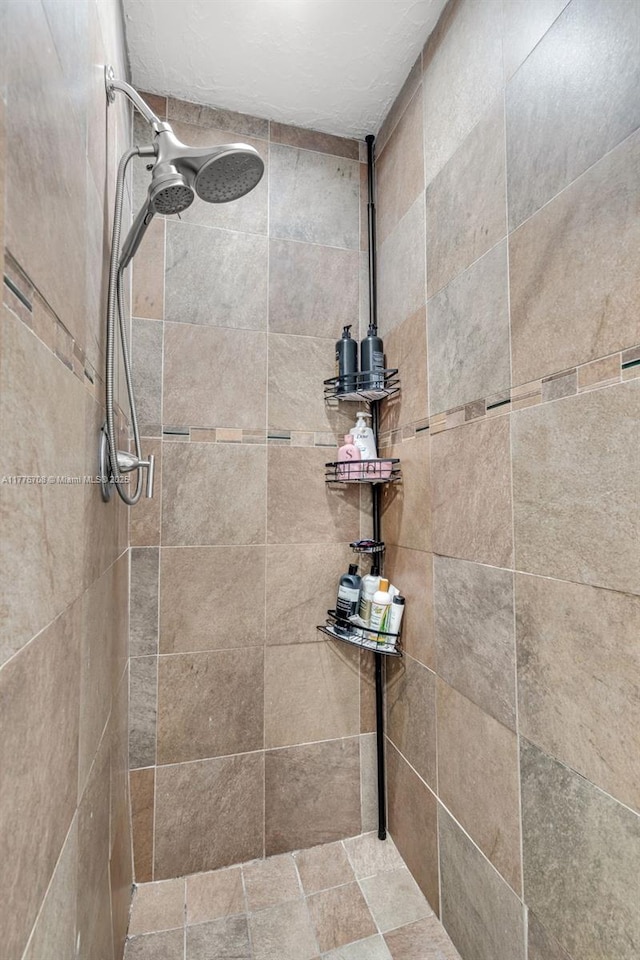 full bath with a tile shower