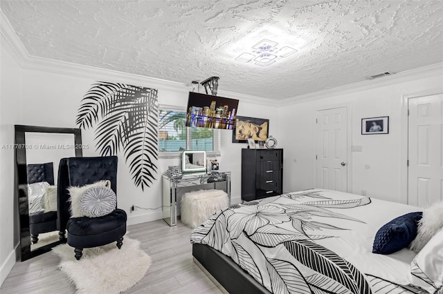 bedroom with visible vents, light wood-style floors, and crown molding