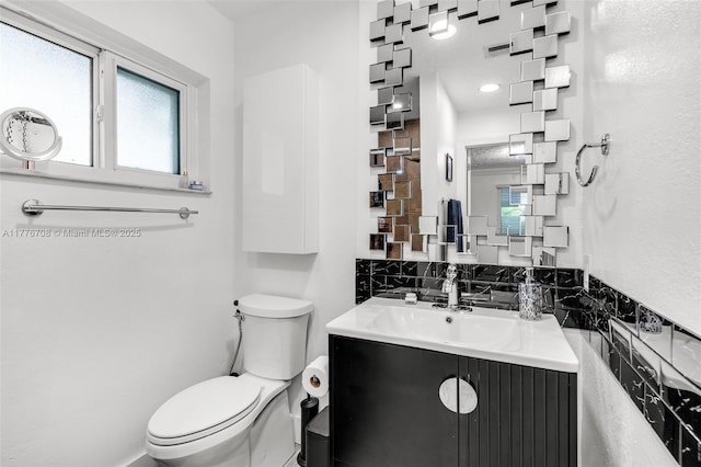 bathroom featuring toilet and vanity
