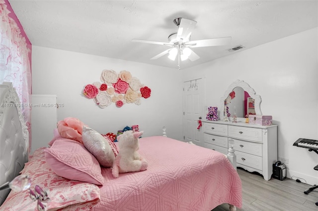 bedroom featuring ceiling fan, visible vents, and light wood-type flooring