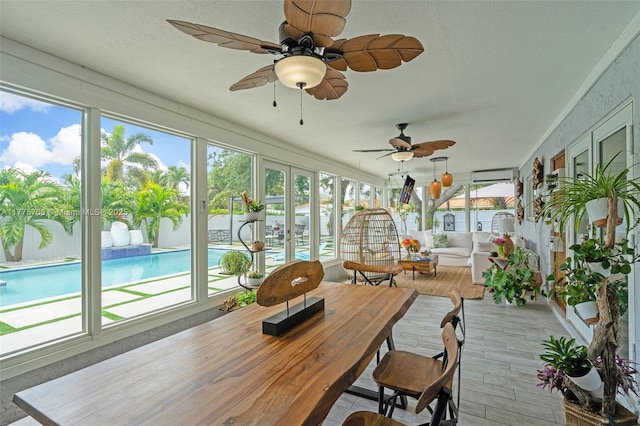 sunroom / solarium with wood finished floors and a textured ceiling