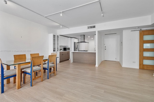 700 Biltmore Way Unit 402, Coral Gables, FL 33134 - dining space featuring rail lighting, a barn door, and light wood-style floors