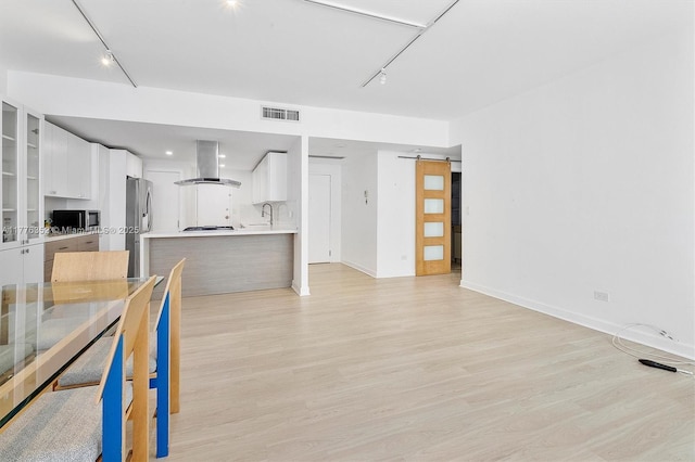 700 Biltmore Way Unit 402, Coral Gables, FL 33134 - unfurnished living room featuring a sink, rail lighting, light wood-type flooring, and baseboards