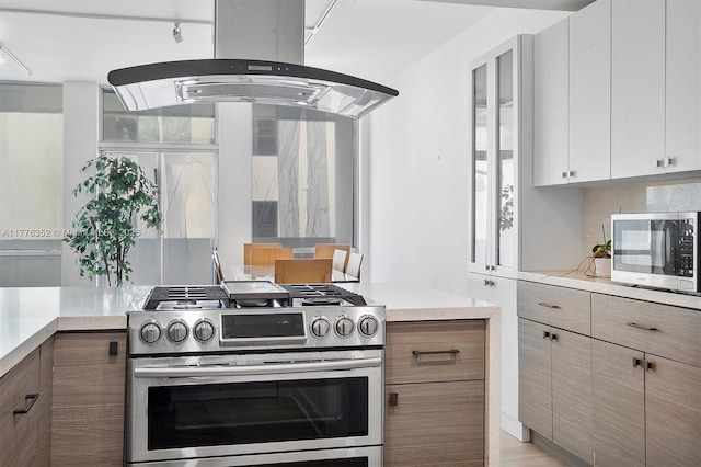 700 Biltmore Way Unit 402, Coral Gables, FL 33134 - kitchen with stainless steel appliances, island range hood, and light countertops