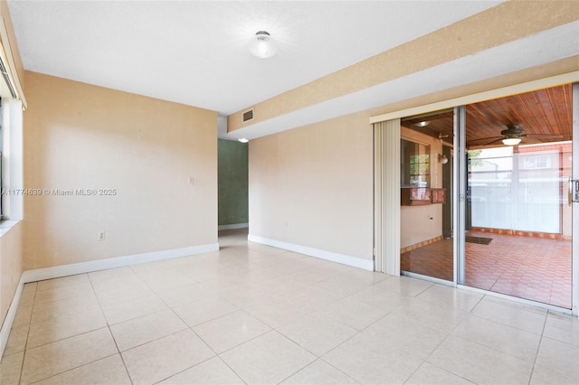 spare room with ceiling fan, light tile patterned flooring, baseboards, and visible vents