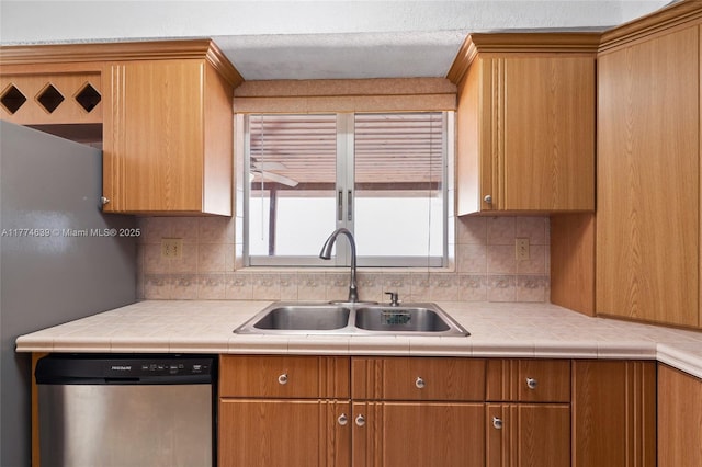 kitchen with a sink, stainless steel dishwasher, decorative backsplash, and brown cabinets