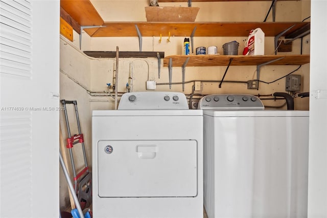 washroom featuring laundry area and washing machine and clothes dryer