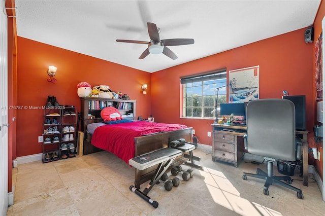 bedroom featuring baseboards and ceiling fan