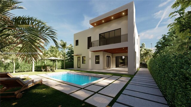5912 SW 33rd St, Miami, FL 33155 - rear view of house with an outdoor pool, a balcony, stucco siding, and a patio area