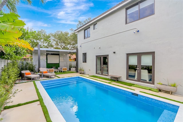 back of house featuring stucco siding, fence, a patio, french doors, and a fenced in pool