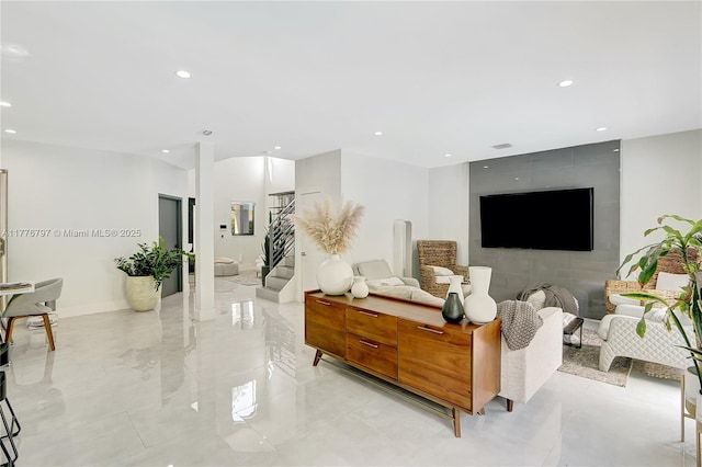 living room with marble finish floor, baseboards, and recessed lighting