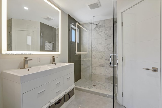 bathroom with a shower stall, visible vents, and a sink