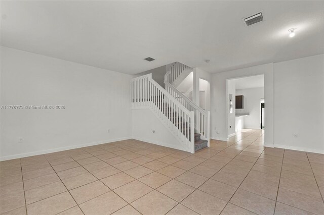 10861 W 32nd Ln Unit 10861, Hialeah, FL 33018 - empty room featuring light tile patterned flooring, stairs, visible vents, and baseboards