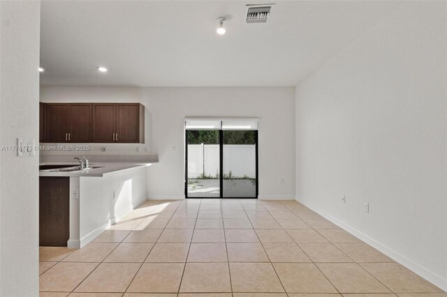 10861 W 32nd Ln Unit 10861, Hialeah, FL 33018 - kitchen featuring light countertops, visible vents, baseboards, dark brown cabinets, and light tile patterned floors