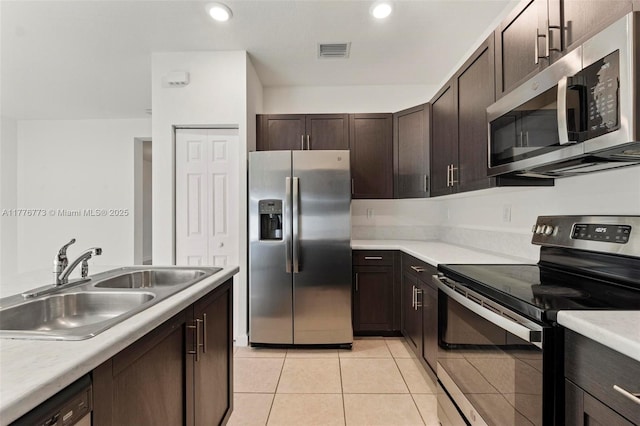 10861 W 32nd Ln Unit 10861, Hialeah, FL 33018 - kitchen with light countertops, light tile patterned floors, a sink, visible vents, and appliances with stainless steel finishes