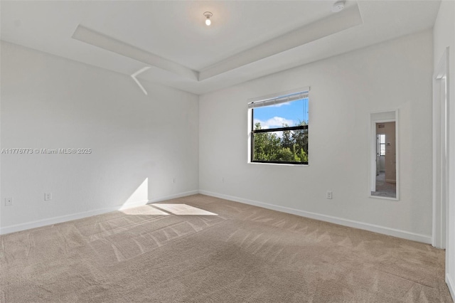 10861 W 32nd Ln Unit 10861, Hialeah, FL 33018 - unfurnished room with a raised ceiling, baseboards, and light colored carpet