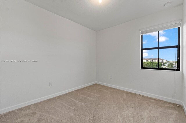 10861 W 32nd Ln Unit 10861, Hialeah, FL 33018 - spare room with baseboards and light colored carpet