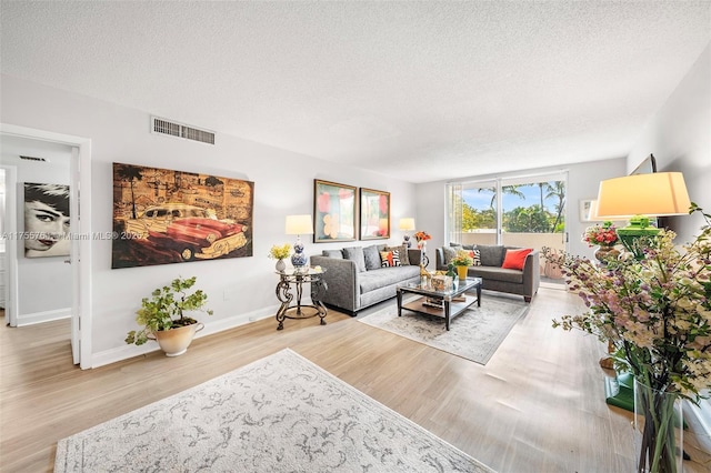 13131 Ixora Ct Unit A-1 A-2 A-3, North Miami, FL 33181 - living area featuring visible vents, a textured ceiling, baseboards, and wood finished floors