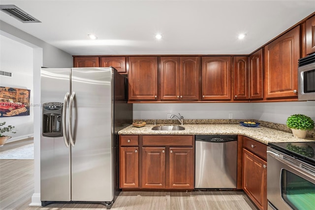 13131 Ixora Ct Unit A-1 A-2 A-3, North Miami, FL 33181 - kitchen featuring light stone countertops, light wood-type flooring, visible vents, a sink, and stainless steel appliances