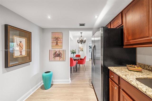 13131 Ixora Ct Unit A-1 A-2 A-3, North Miami, FL 33181 - kitchen with stainless steel fridge with ice dispenser, a notable chandelier, light stone counters, light wood-style floors, and visible vents