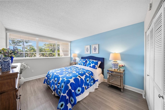 13131 Ixora Ct Unit A-1 A-2 A-3, North Miami, FL 33181 - bedroom featuring a textured ceiling, wood finished floors, baseboards, and a closet