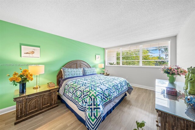 13131 Ixora Ct Unit A-1 A-2 A-3, North Miami, FL 33181 - bedroom with baseboards, wood finished floors, and a textured ceiling
