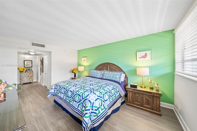 13131 Ixora Ct Unit A-1 A-2 A-3, North Miami, FL 33181 - bedroom with visible vents, baseboards, wood finished floors, and a textured ceiling