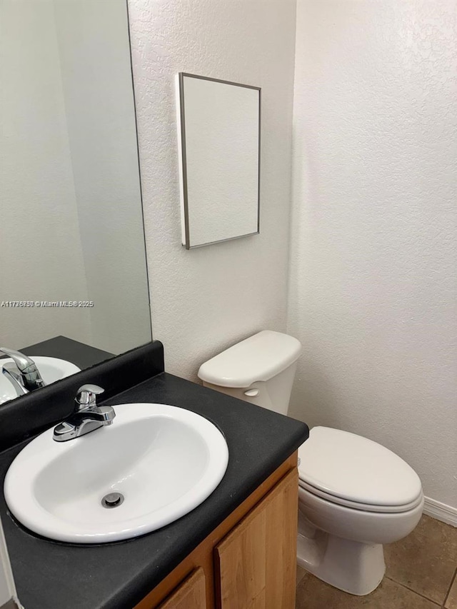 2062 NE 167th St Unit 3-112, North Miami Beach, FL 33162 - bathroom featuring vanity, tile patterned floors, toilet, and baseboards