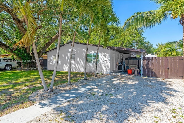 view of side of home featuring fence