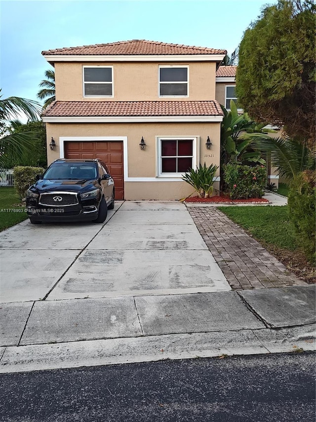 10521 SW 13th Ct, Pembroke Pines, FL 33025 - view of front of property with a tiled roof, driveway, stucco siding, and a garage