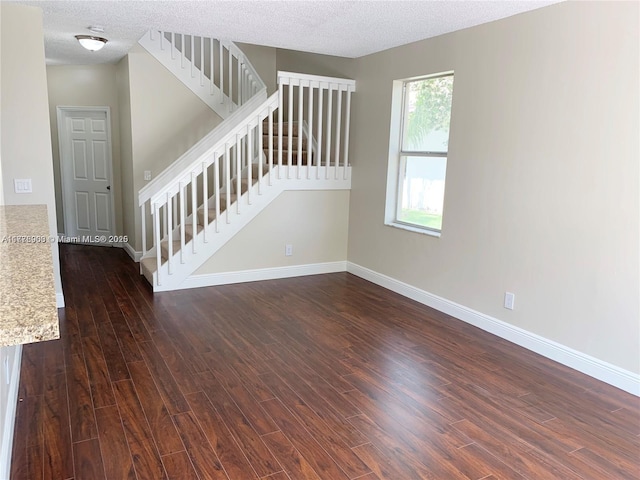 10521 SW 13th Ct, Pembroke Pines, FL 33025 - spare room featuring baseboards, stairway, and dark wood finished floors