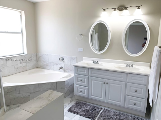 10521 SW 13th Ct, Pembroke Pines, FL 33025 - bathroom featuring a sink, double vanity, marble finish floor, and a garden tub