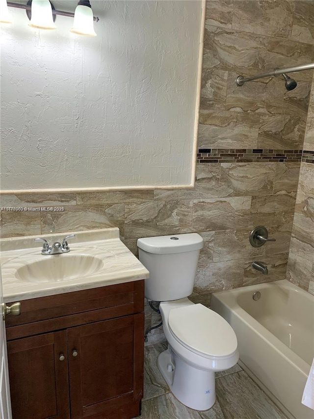 10521 SW 13th Ct, Pembroke Pines, FL 33025 - bathroom with tile walls, toilet, vanity, shower / bathtub combination, and a wainscoted wall