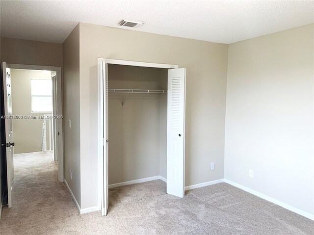 10521 SW 13th Ct, Pembroke Pines, FL 33025 - unfurnished bedroom featuring light carpet, visible vents, a closet, and baseboards
