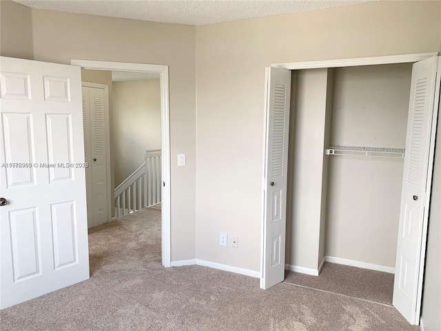 10521 SW 13th Ct, Pembroke Pines, FL 33025 - unfurnished bedroom featuring a closet, baseboards, carpet flooring, and a textured ceiling