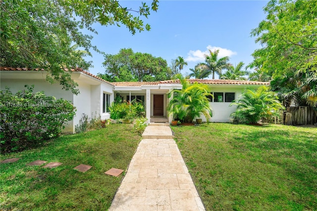 10619 NE 10th Pl, Miami Shores, FL 33138 - mediterranean / spanish-style home featuring stucco siding and a tiled roof