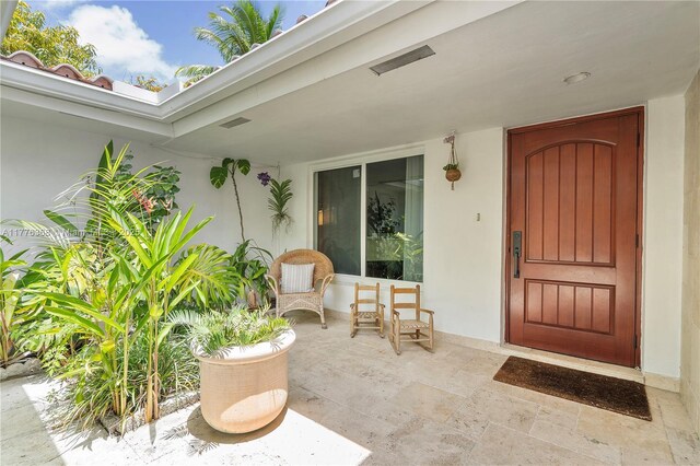 10619 NE 10th Pl, Miami Shores, FL 33138 - doorway to property featuring stucco siding