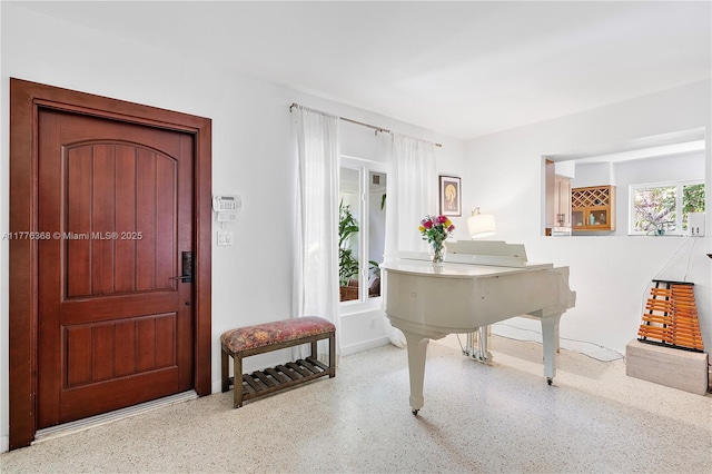10619 NE 10th Pl, Miami Shores, FL 33138 - foyer featuring speckled floor and baseboards