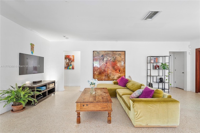 10619 NE 10th Pl, Miami Shores, FL 33138 - living room featuring visible vents, speckled floor, and baseboards