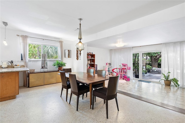10619 NE 10th Pl, Miami Shores, FL 33138 - dining space with dark aggregate flooring