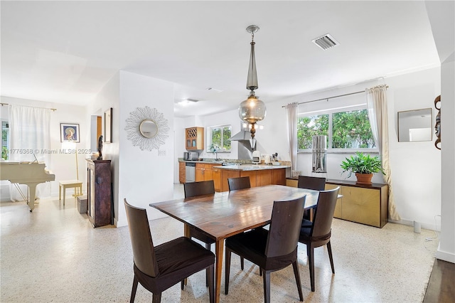 10619 NE 10th Pl, Miami Shores, FL 33138 - dining area featuring dark aggregate flooring and baseboards