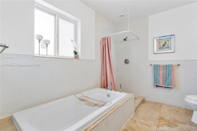10619 NE 10th Pl, Miami Shores, FL 33138 - bathroom with tile walls, a garden tub, a tile shower, and tile patterned floors