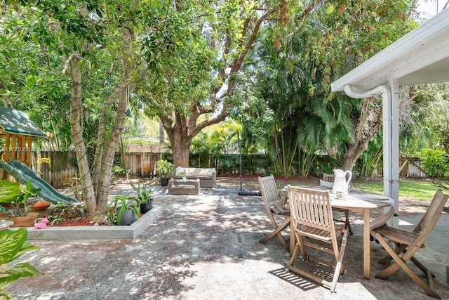 10619 NE 10th Pl, Miami Shores, FL 33138 - fenced backyard featuring an outdoor living space, a patio, outdoor dining area, and a playground