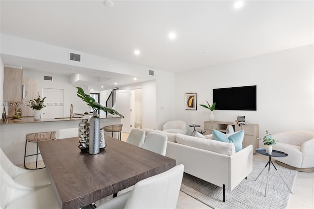 living area featuring visible vents, recessed lighting, and light tile patterned floors
