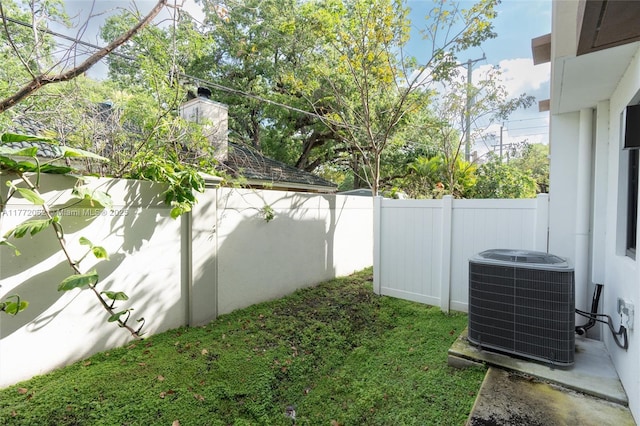 view of yard with a fenced backyard and cooling unit